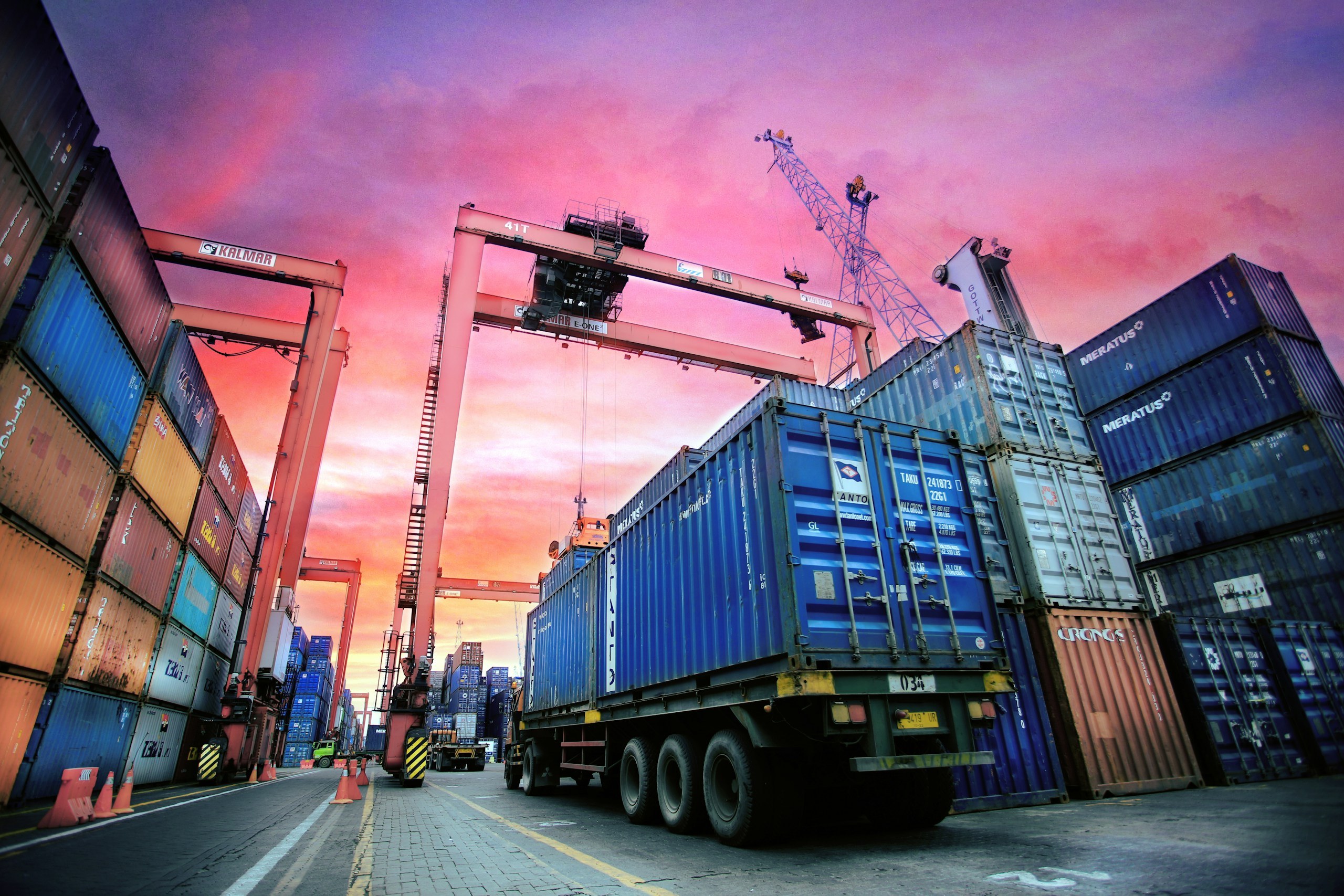 Containers and cranes at a busy international port.